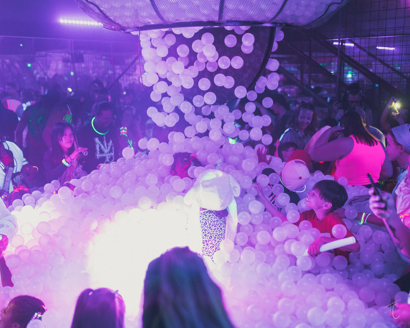Kids in the glow-lit ball pit