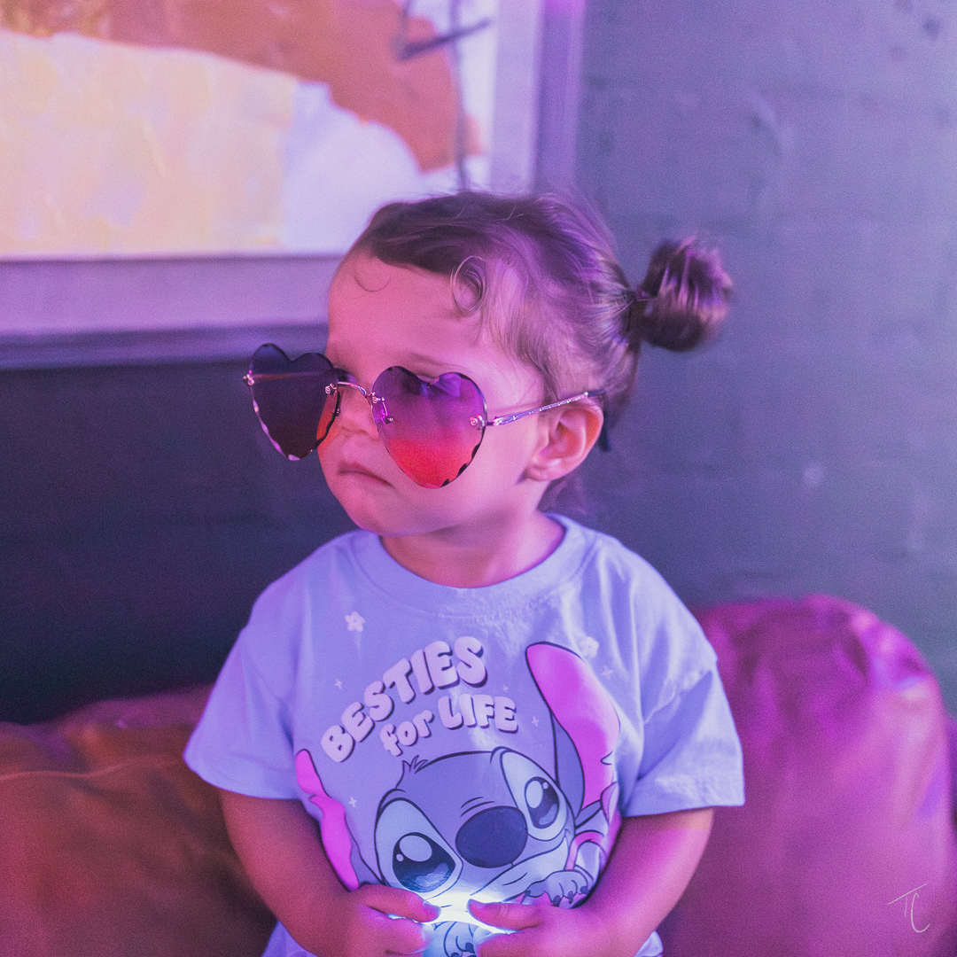 Kid with sunglasses at the rave